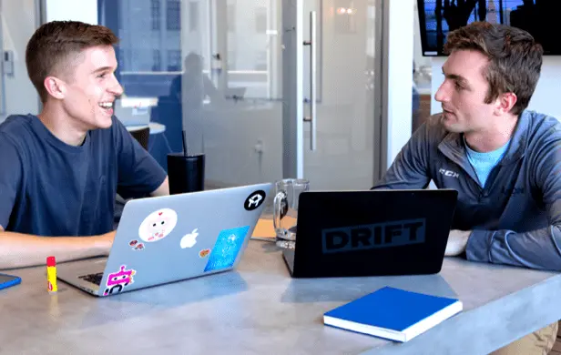 two salesloft members on laptops